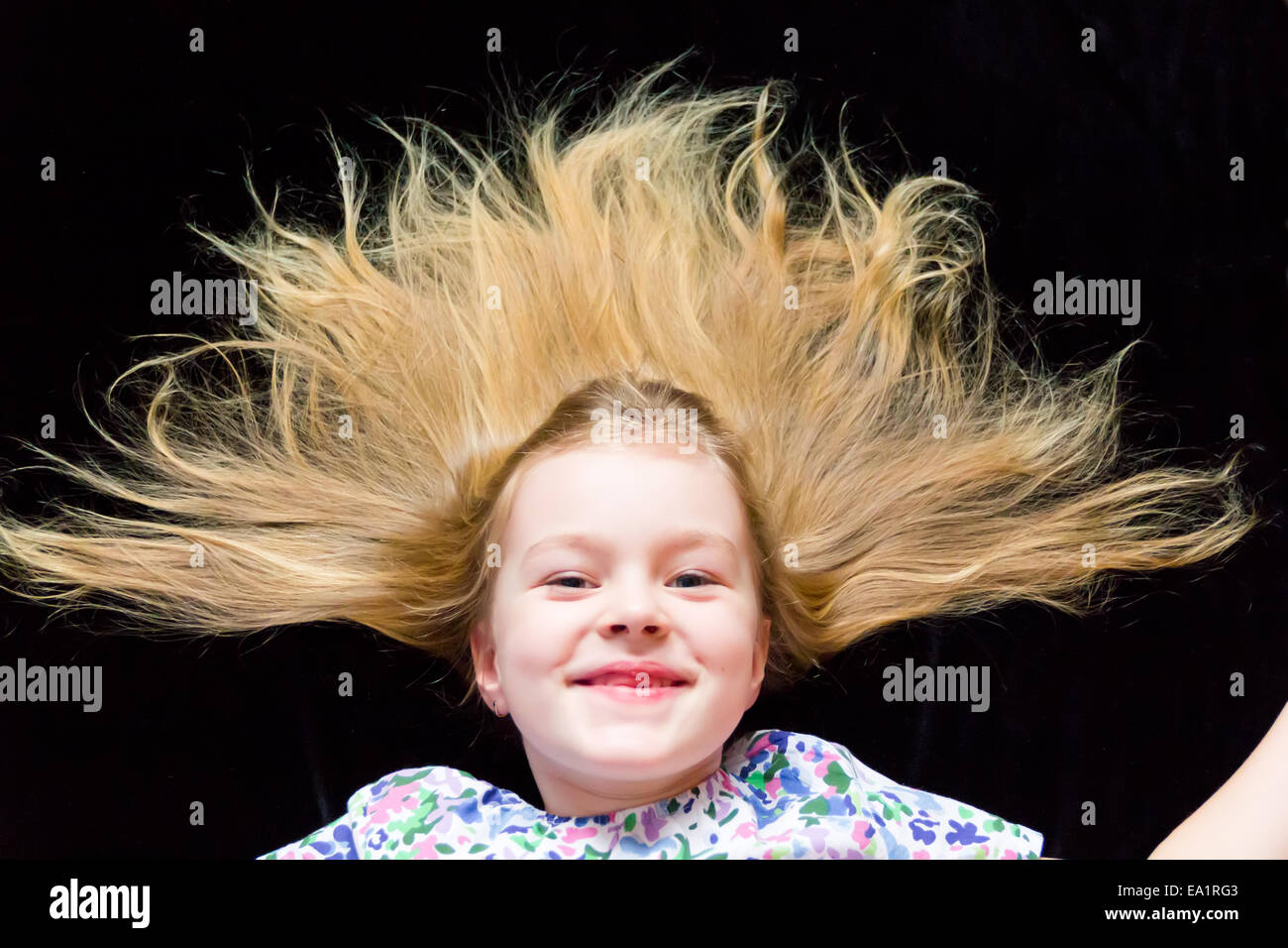 Smiling girl makes faces imitate witch Stock Photo