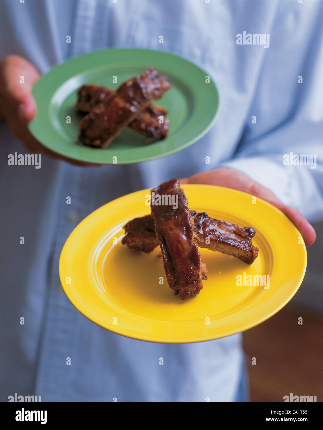 ribs on plate being handed out Stock Photo
