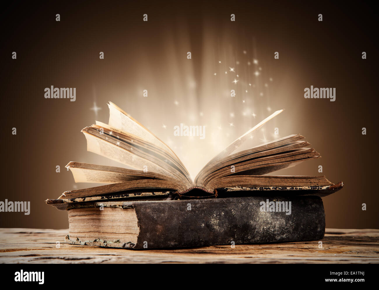 Old books on wooden planks with blur shimmer background Stock Photo