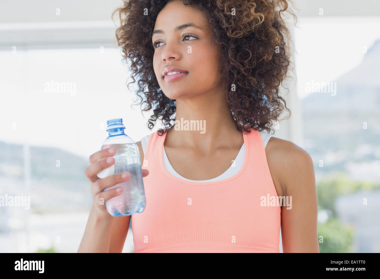 Fit female holding water bottle at gym Stock Photo
