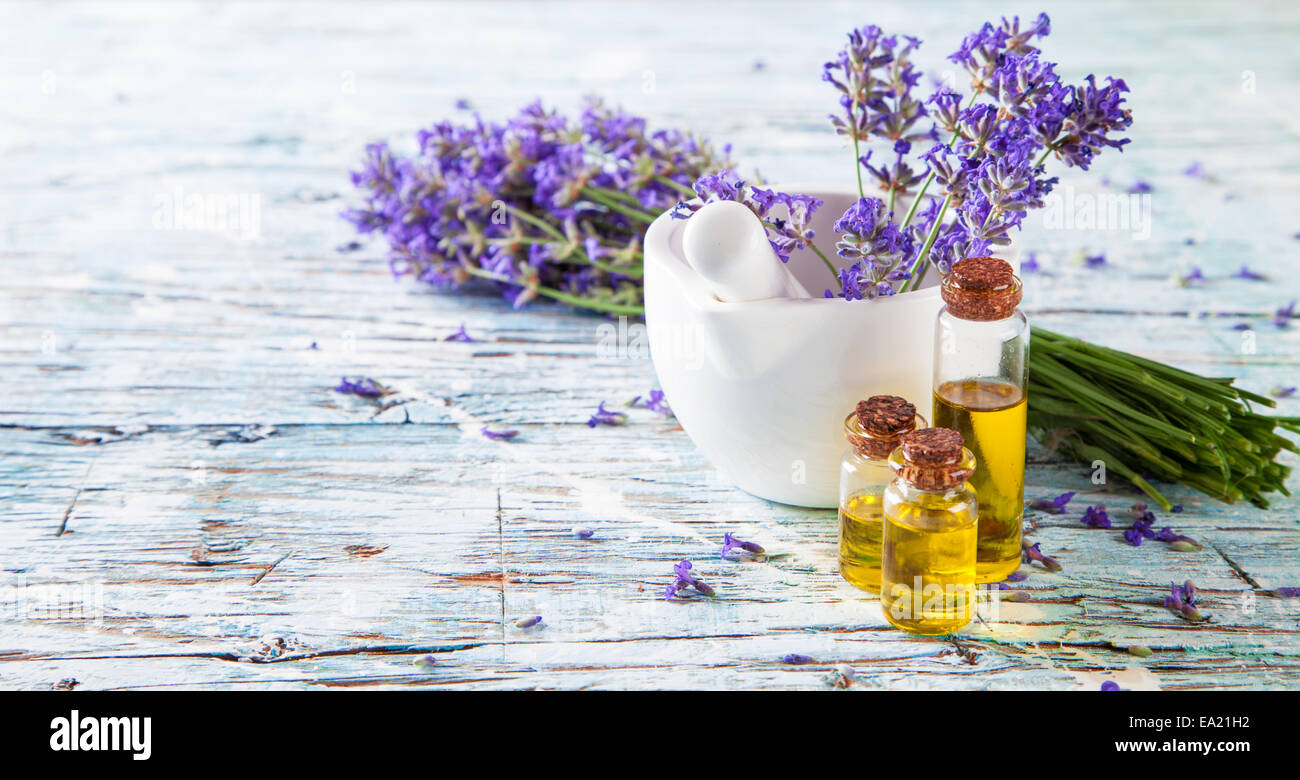 Lavender bunch with oil and soap on white wood Stock Photo