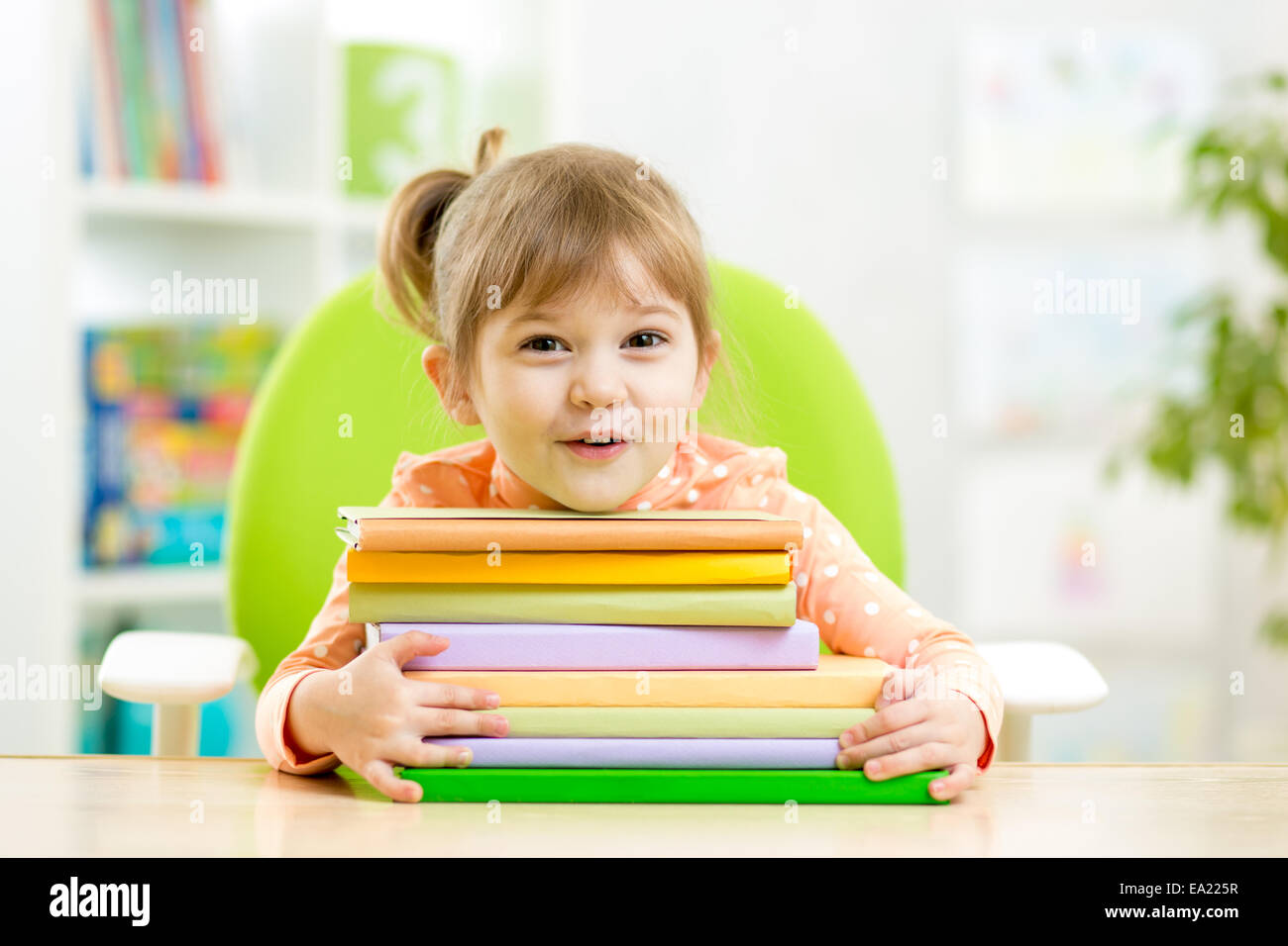 Cute kid girl preschooler with books Stock Photo - Alamy