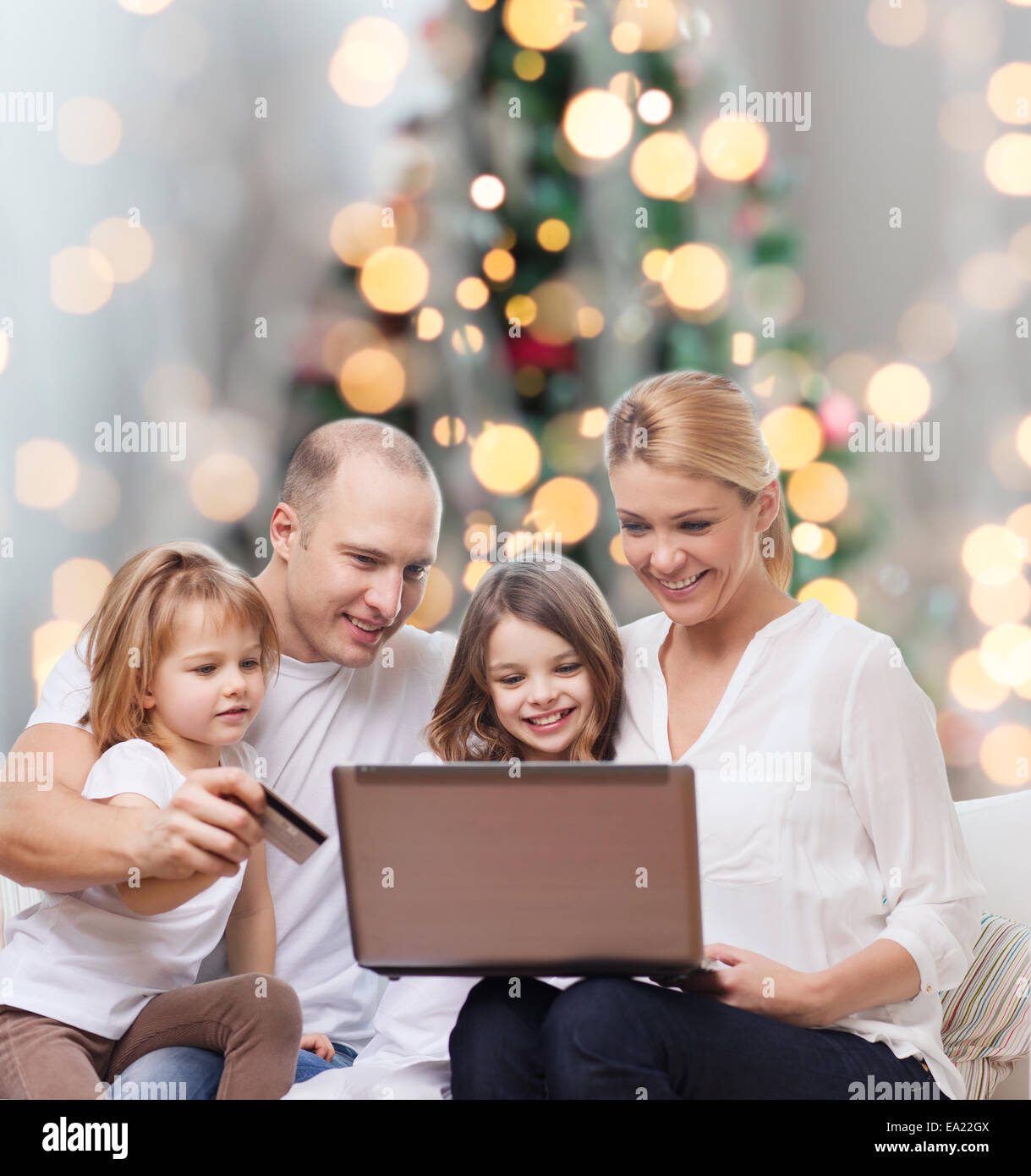 happy family with laptop computer and credit card Stock Photo