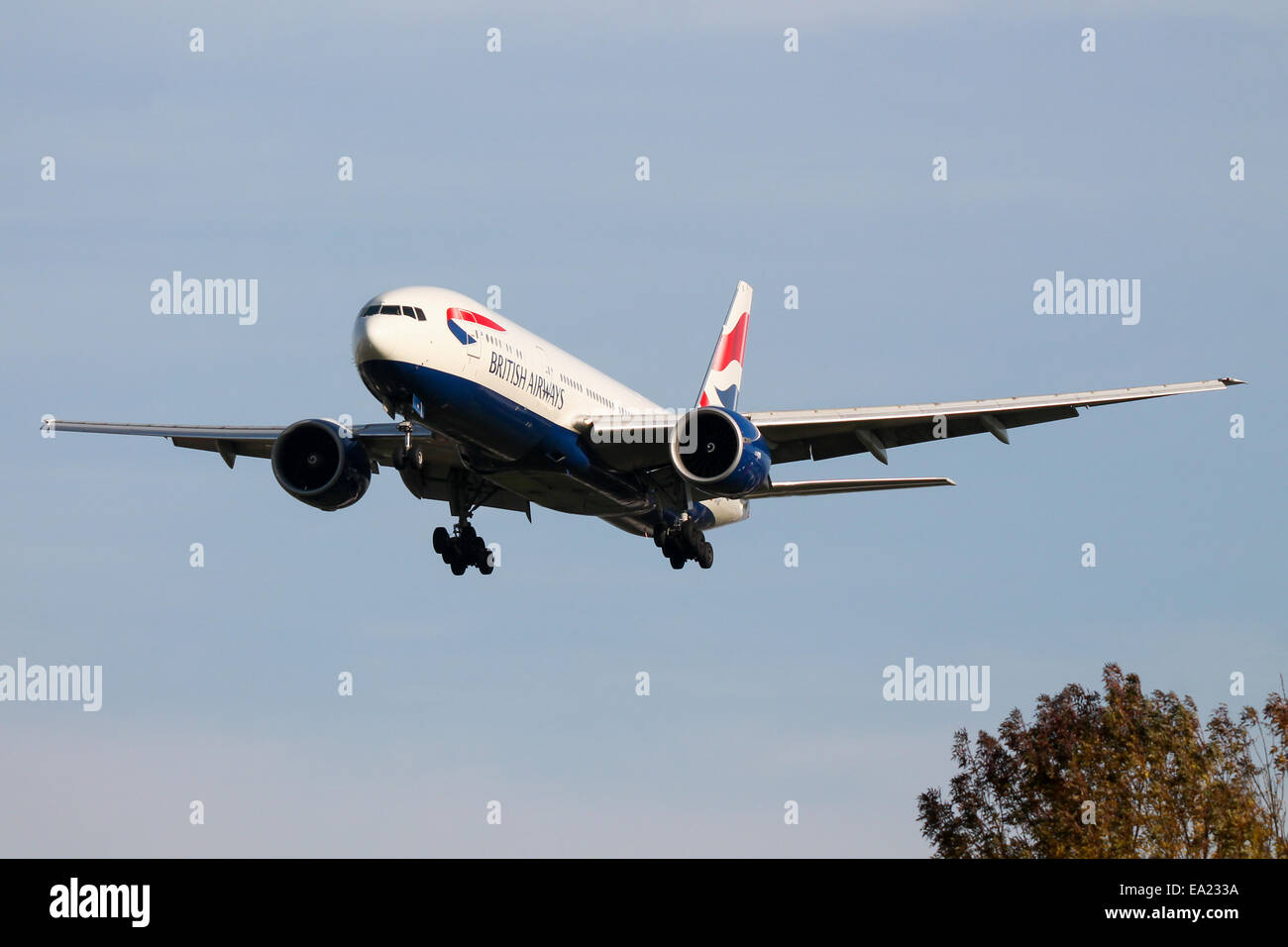 British Airways Boeing 777-200 approaches runway 27L at London Heathrow Airport. Stock Photo
