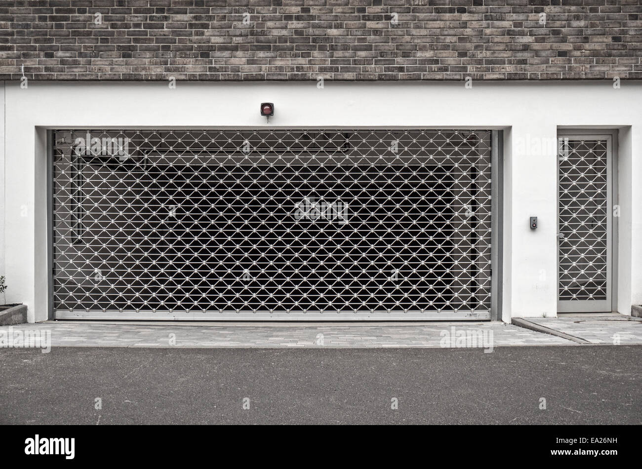 Entrance of a parking garage, closed with a barred gate. Stock Photo