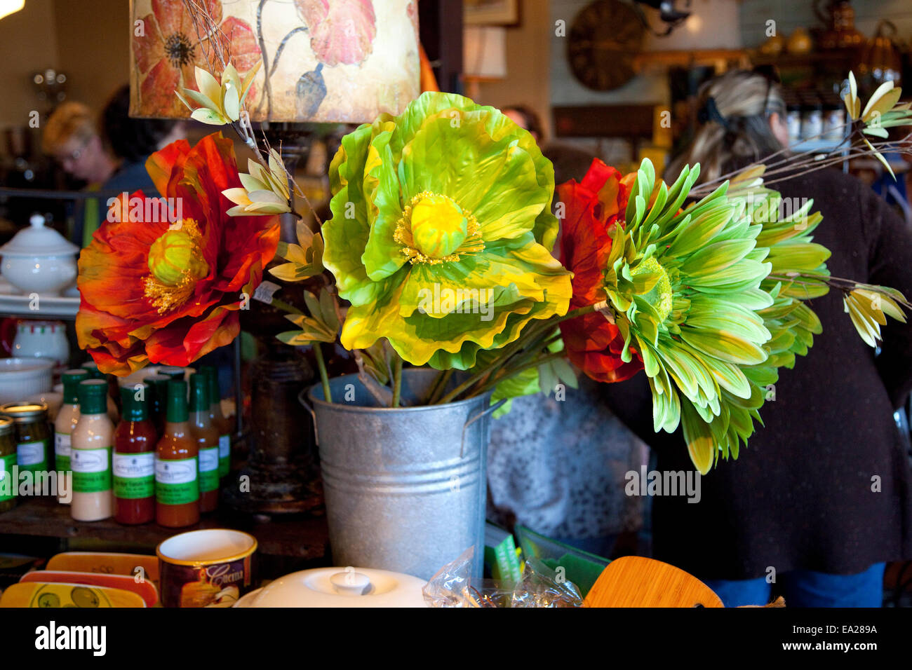 Rustic bucket filled with large red and green splashy artificial