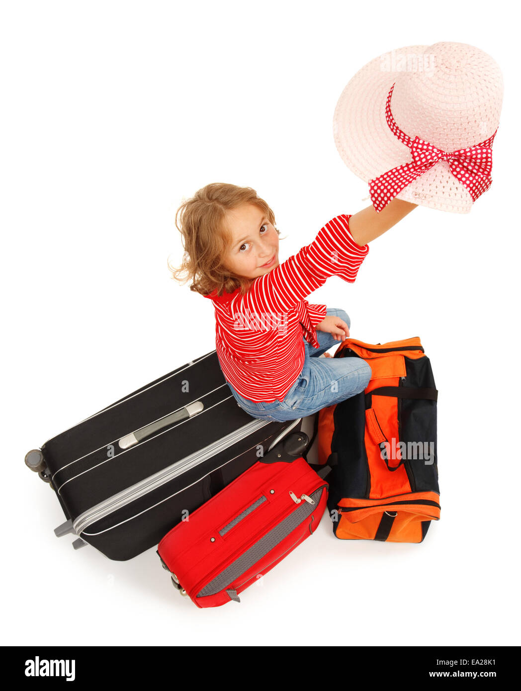 Little traveler girl waving with her hat Stock Photo