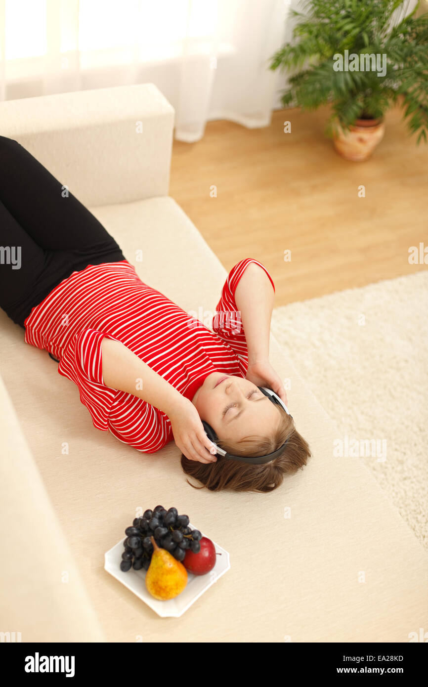 Teen girl laying on sofa hi-res stock photography and images - Alamy