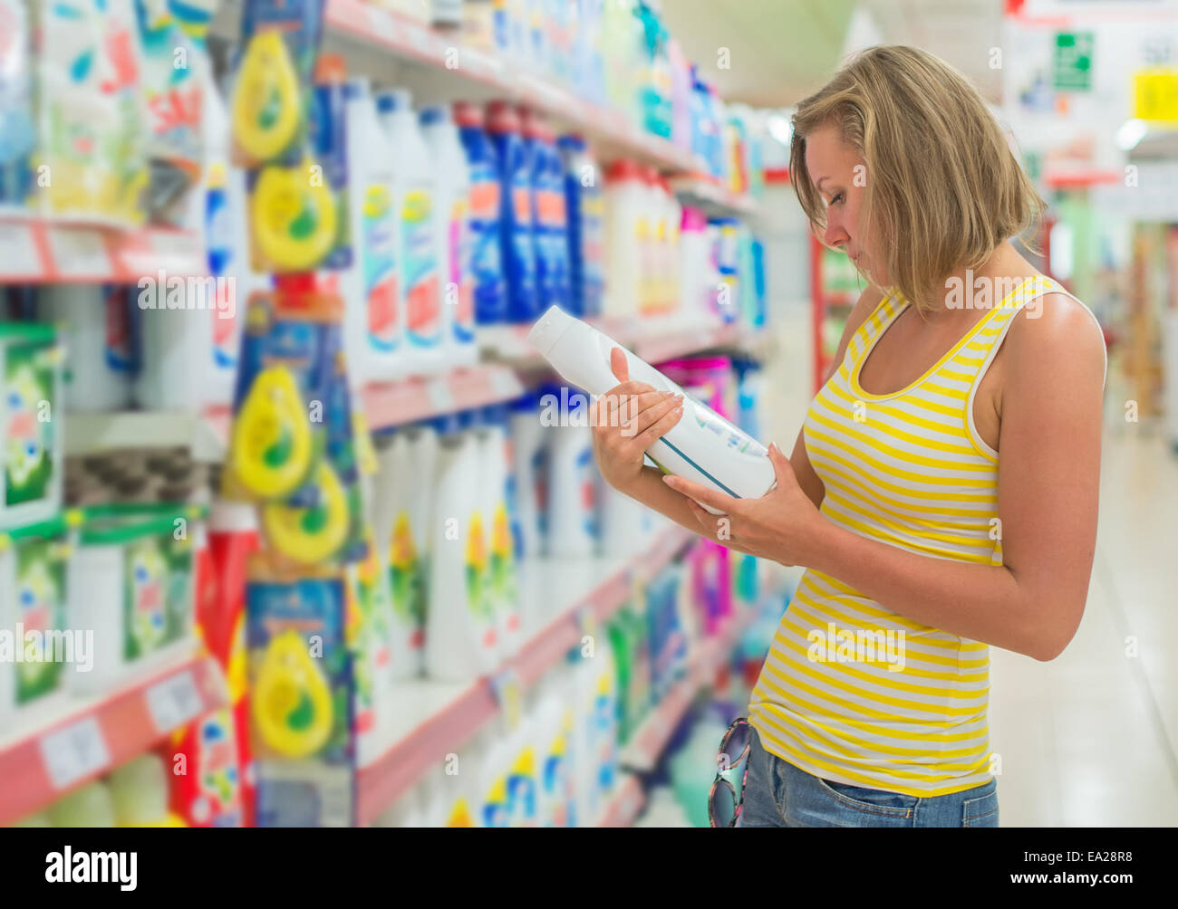 Woman choosing laundry detergent in grocery store Stock Photo Alamy
