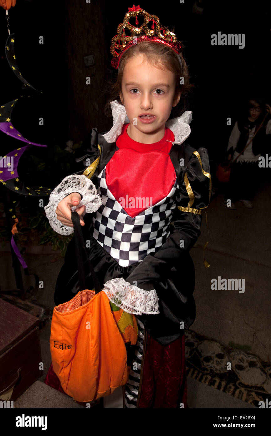 Young girl trick or treating in her Halloween costume wearing a tiara