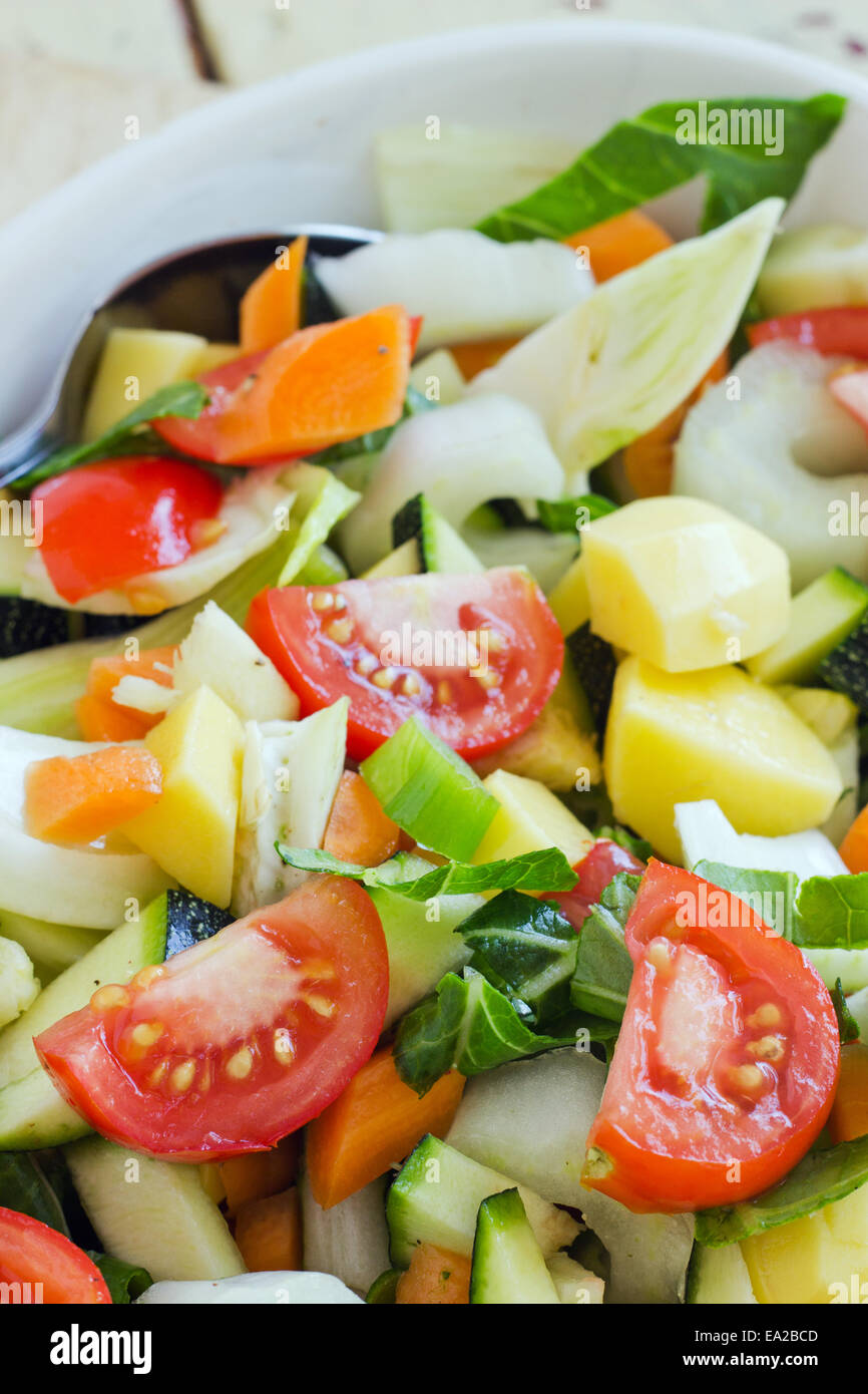 Baking dish with fresh vegetables and spoon Stock Photo