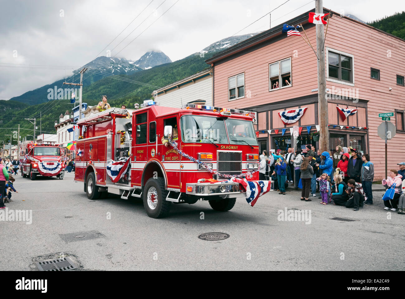 Fire Department trucks roll down Broadway in Fourth of July Parade; Skagway Alaska Stock Photo