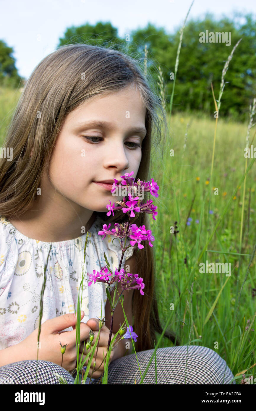 Young girl smelling a flower Stock Photo