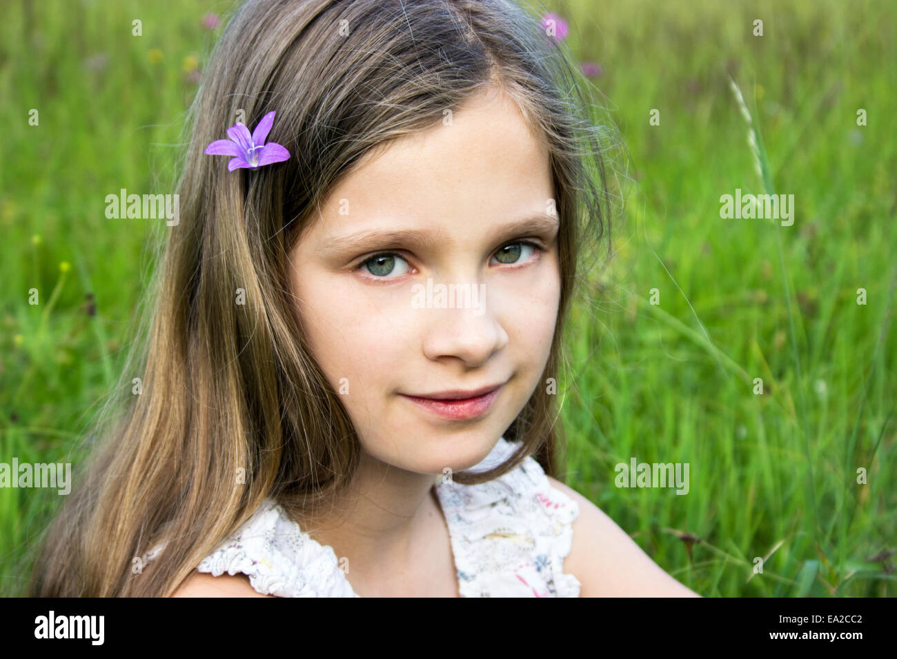 Young, smiling girl in a meadow Stock Photo