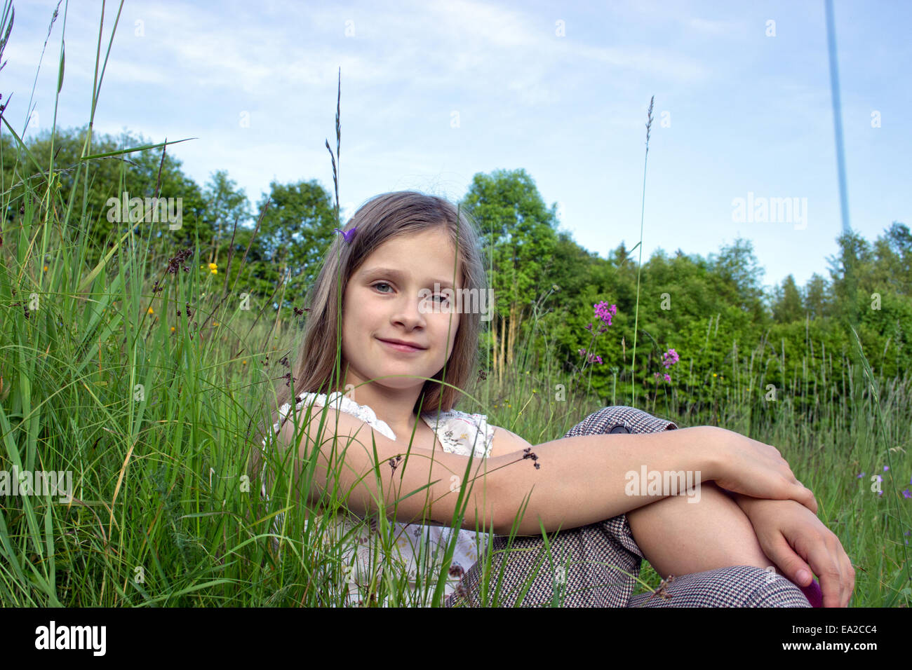 Young, smiling girl in a meadow Stock Photo