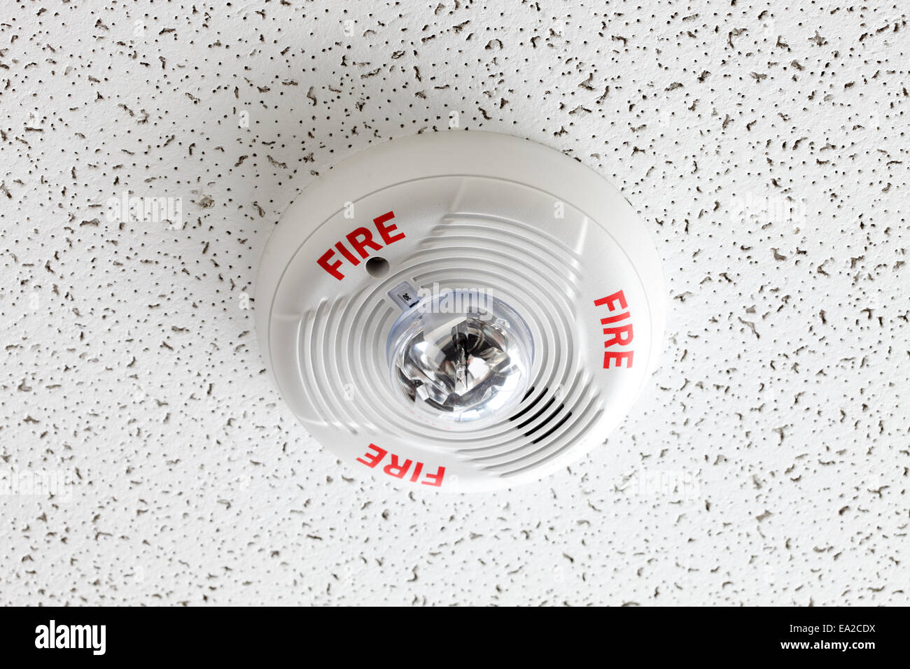 A ceiling mounted fire alarm and smoke detector Stock Photo