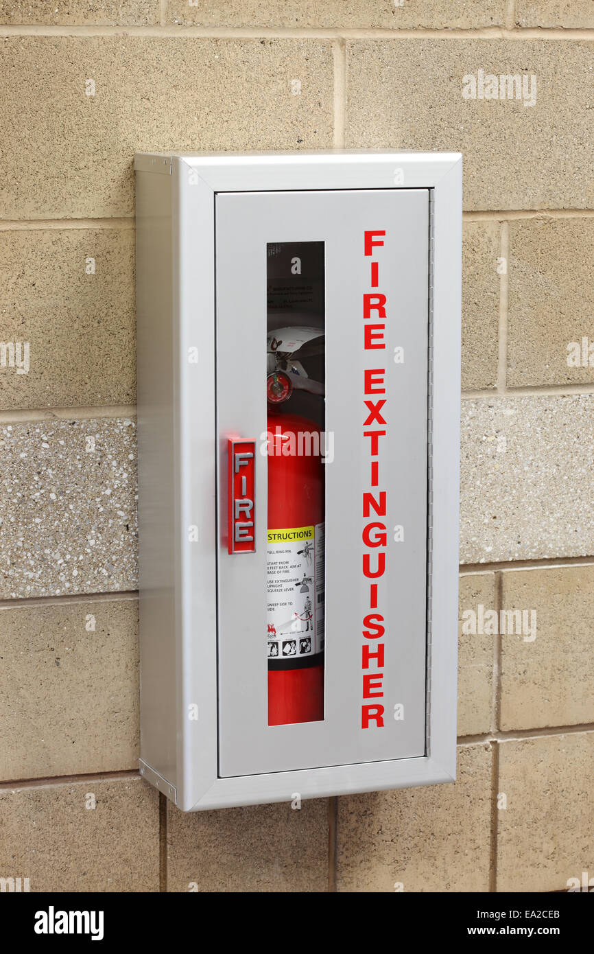 A fire extinguisher in a wall mounted storage box Stock Photo Alamy