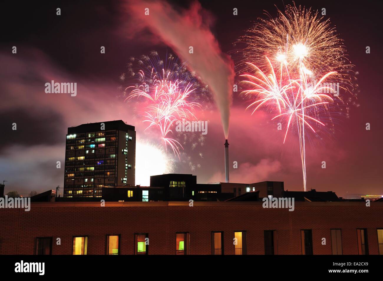 Glasgow, Scotland, UK. 05th Nov, 2014. Fireworks explode in Glasgow Green to celebrate Guy Fawkes night with Gorbals flats in the foreground Credit:  Tony Clerkson/Alamy Live News Stock Photo