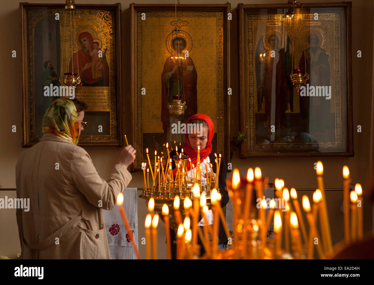 Lighting candles in Vladimirskaya Church in Saint Petersburg, the