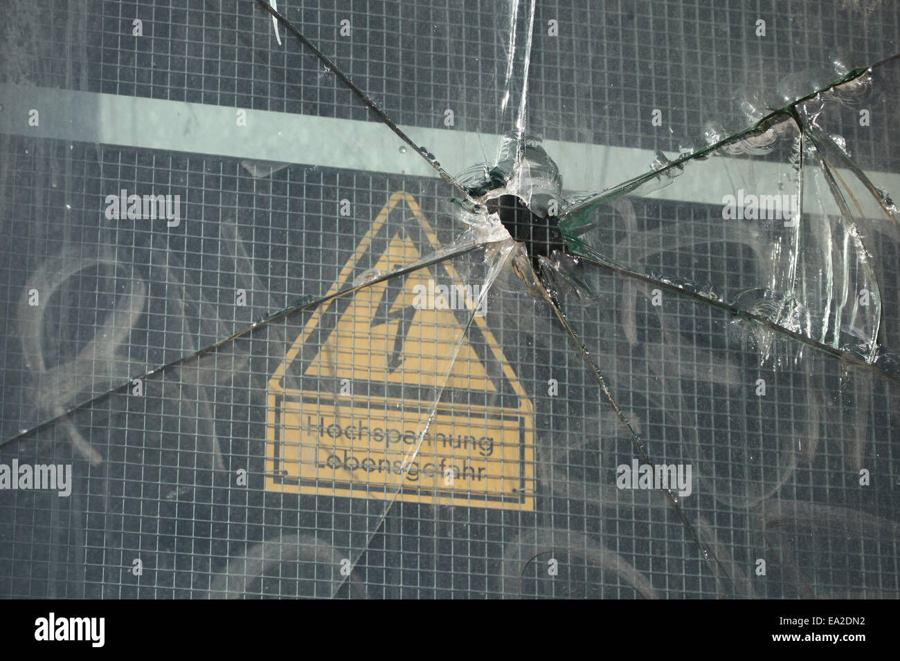 Broken glass on an electric box with a high voltage sign in Dresden, Saxony, Germany. Stock Photo
