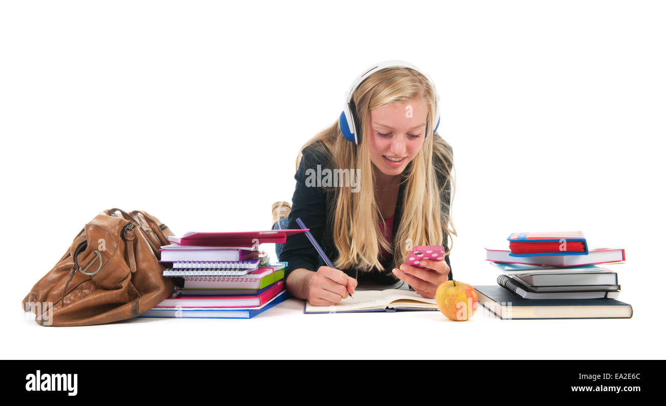 Teen girl with distraction bij the cell phone while making homework for school Stock Photo
