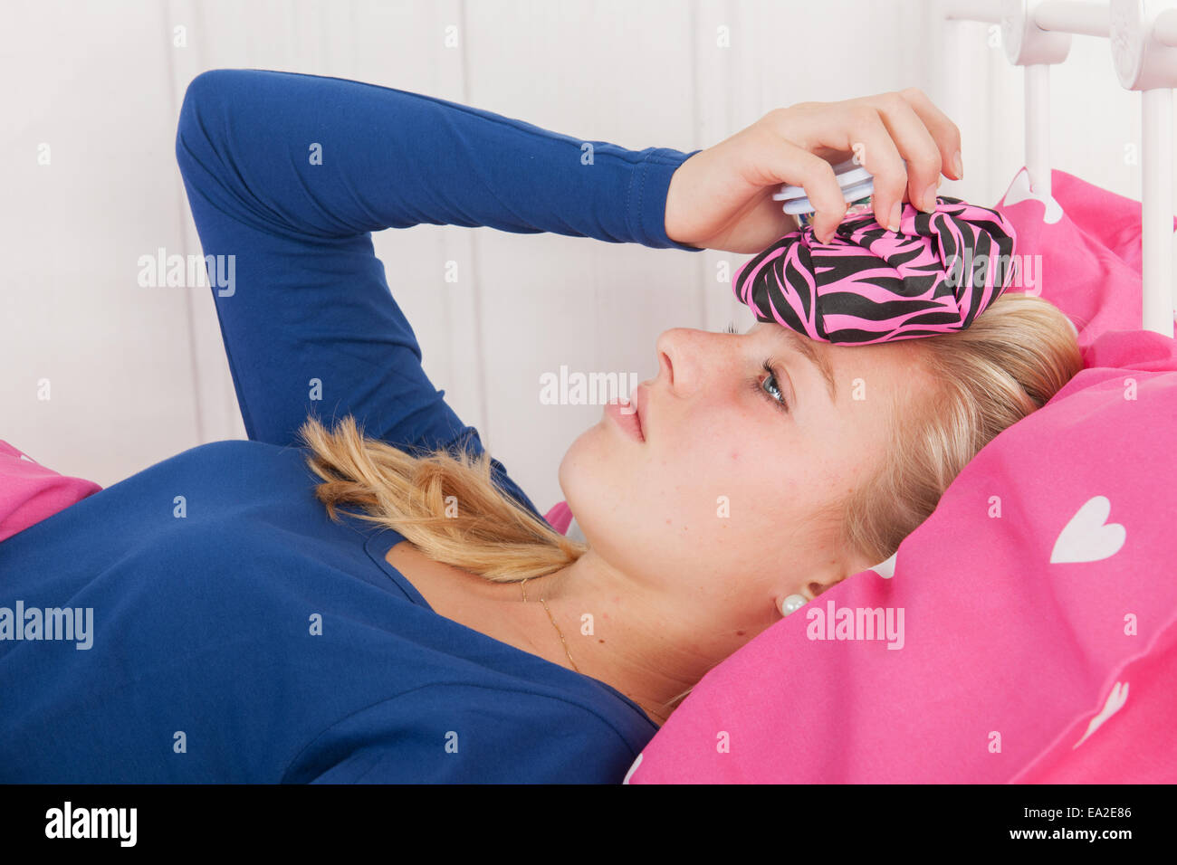 Fourteen year old girl is having a headache Stock Photo