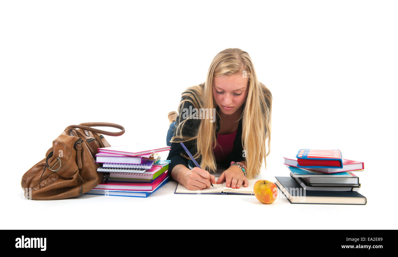 Teen girl laying at the floor and making homework for school Stock Photo