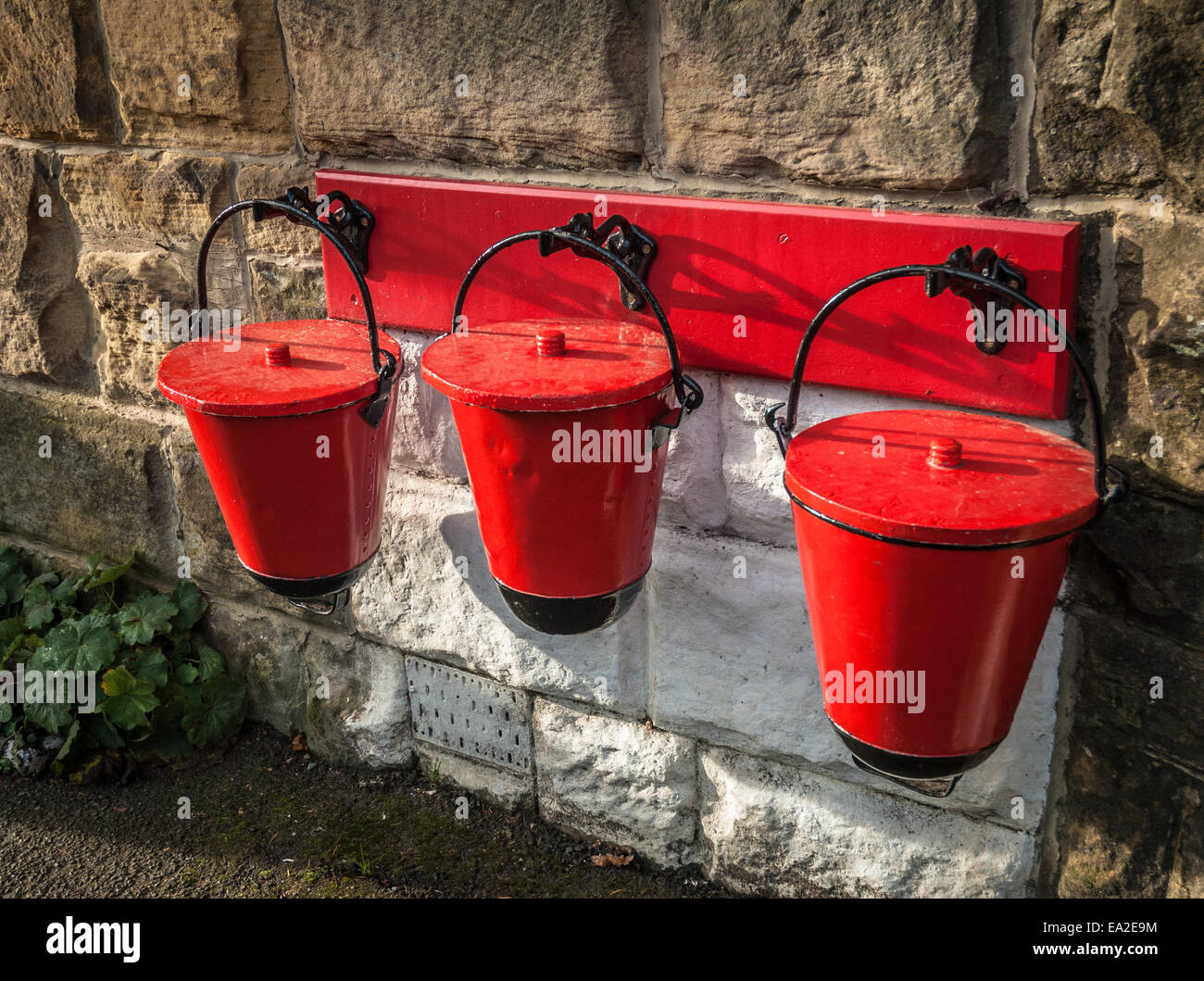 Retro fire sand buckets at an old railway station platform. Stock Photo