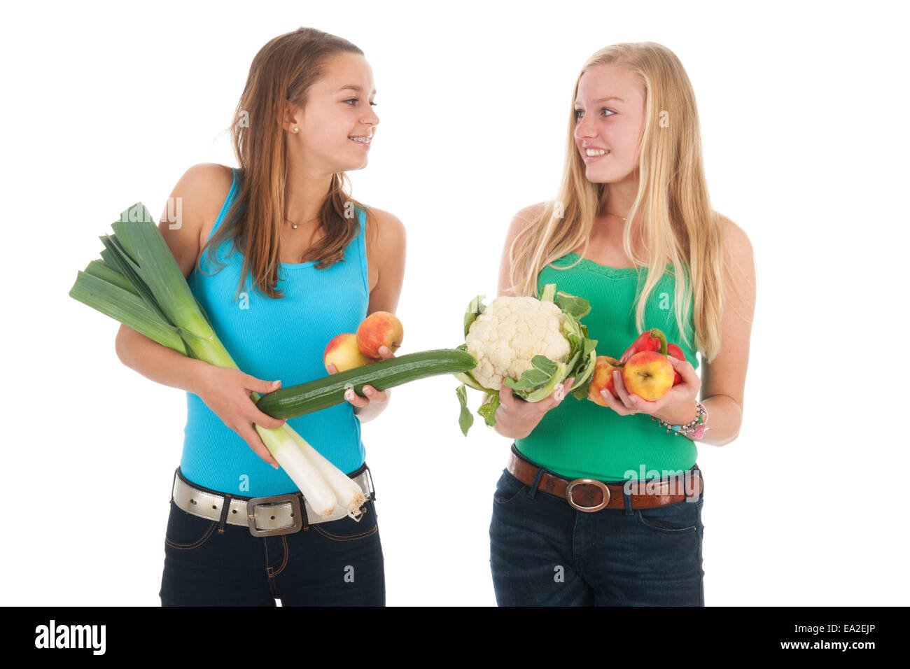 Teen girlfriends with many healthy vegetables and fresh fruit isolated over white background Stock Photo