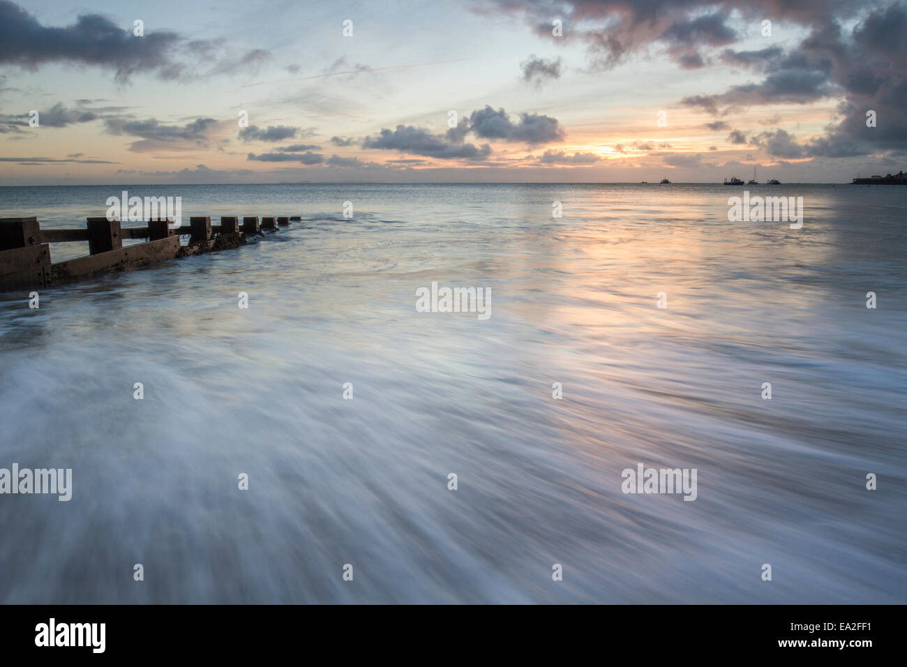 landscape with sunrise in Swanage bay with waves and sea Stock Photo ...