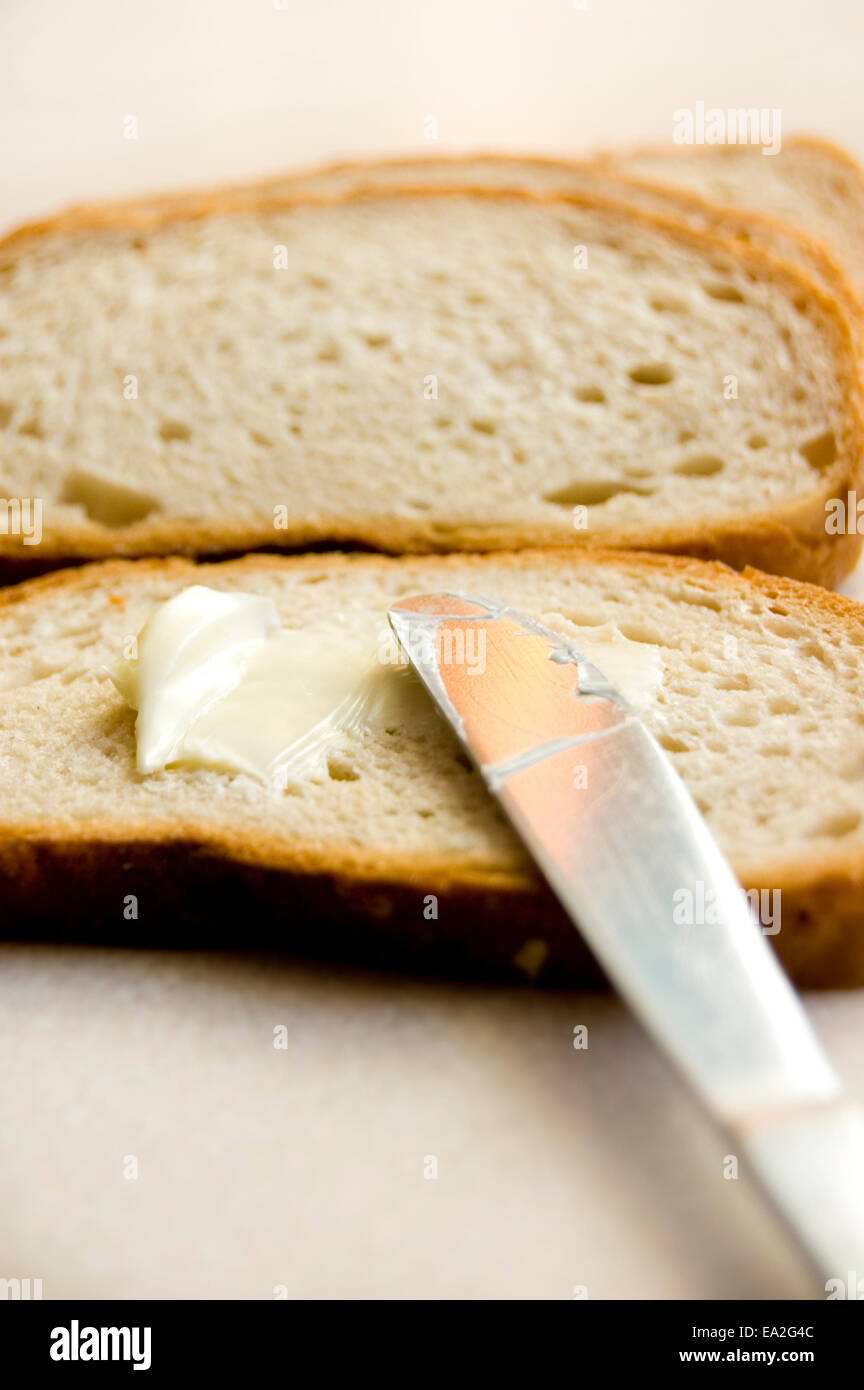 Bread and butter conceptual image. Bread with butter. Stock Photo