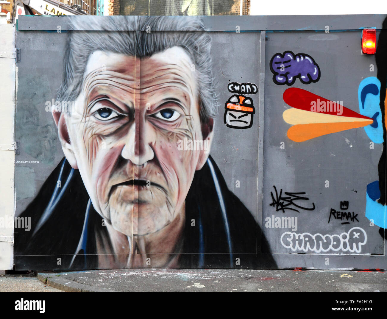 7 feet high portrait of a mans face on street hoarding in East London, England Stock Photo