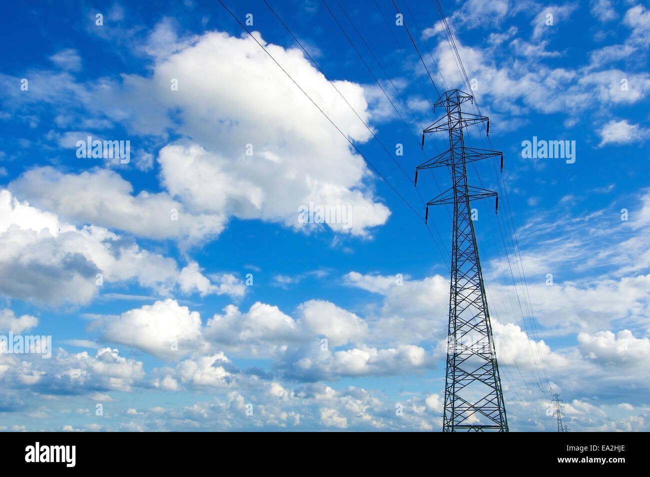 Power lines against the blue sky Stock Photo - Alamy