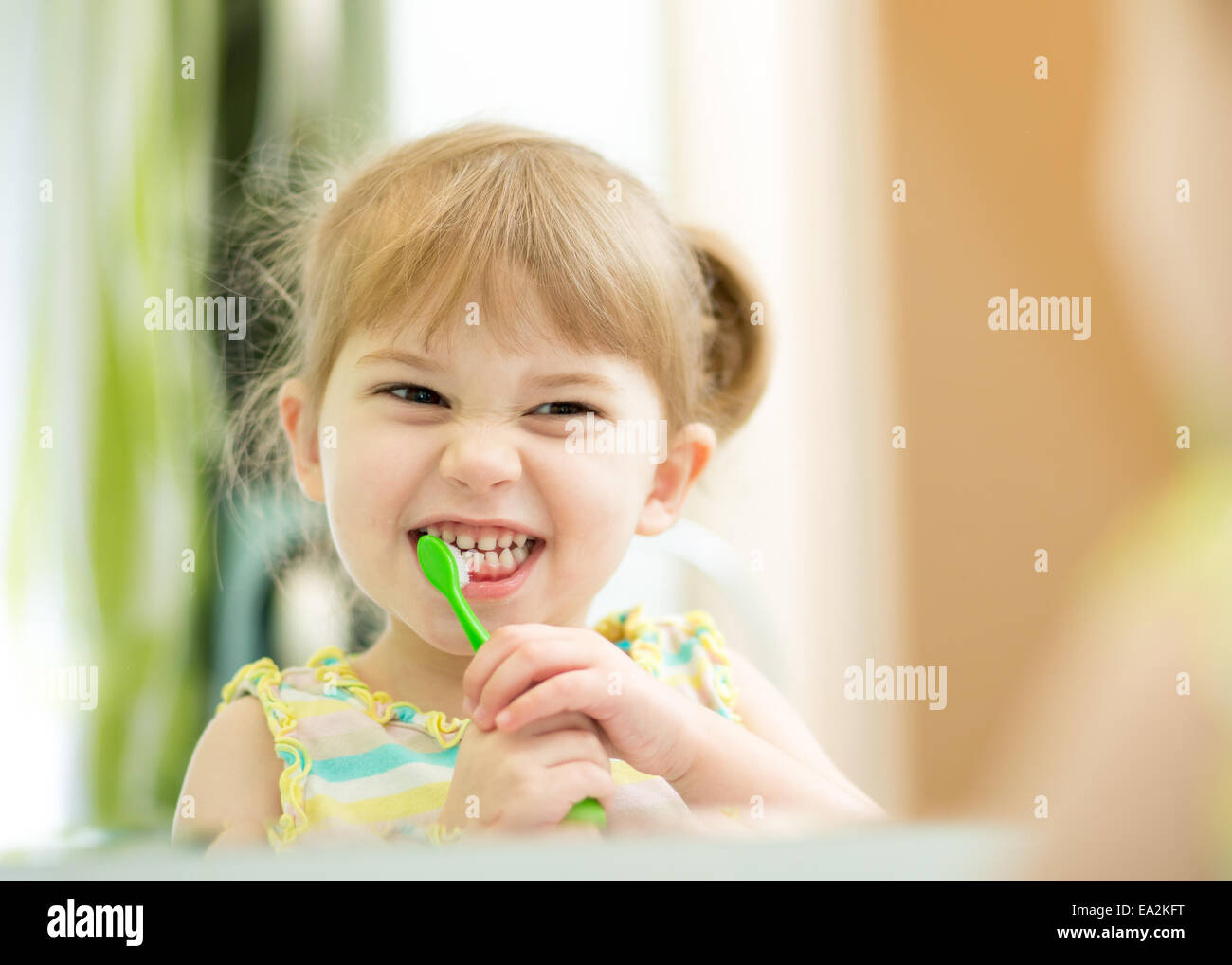 funny child girl brushing teeth Stock Photo