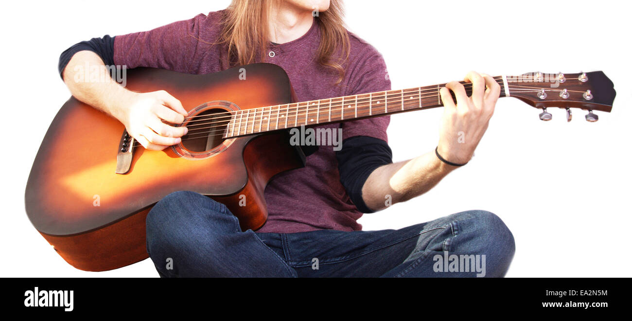 Music conceptual image. Rock musician. Guitarist play on his acoustic guitar. Stock Photo