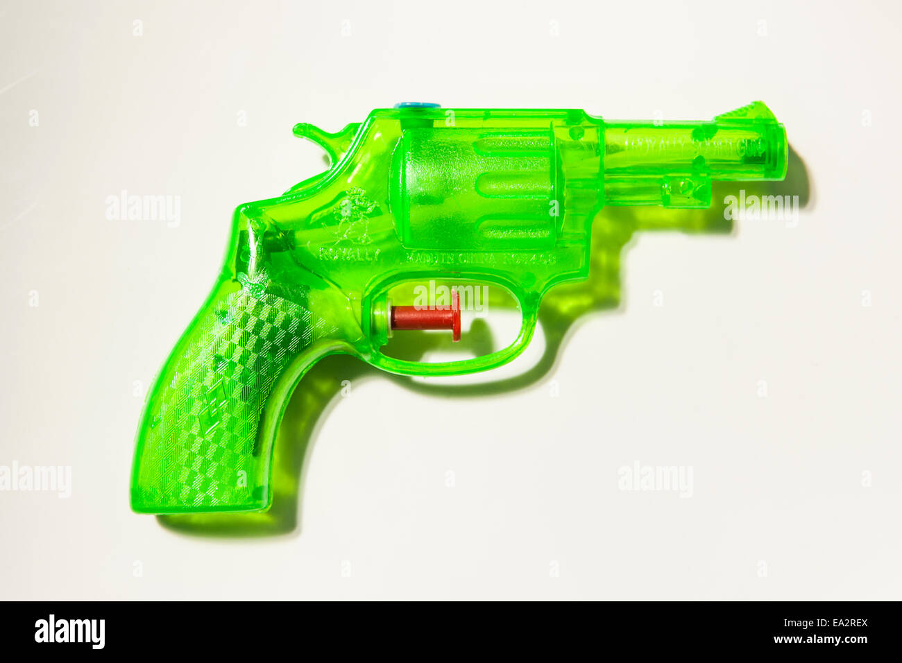 Green transparent plastic water pistol isolated on a white background Stock Photo