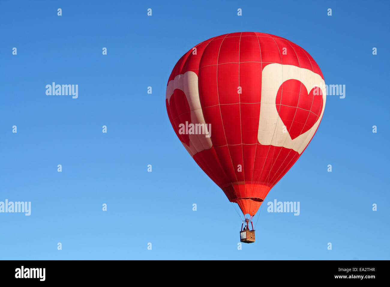 Colorful hot air balloon against a clear blue sky Stock Photo