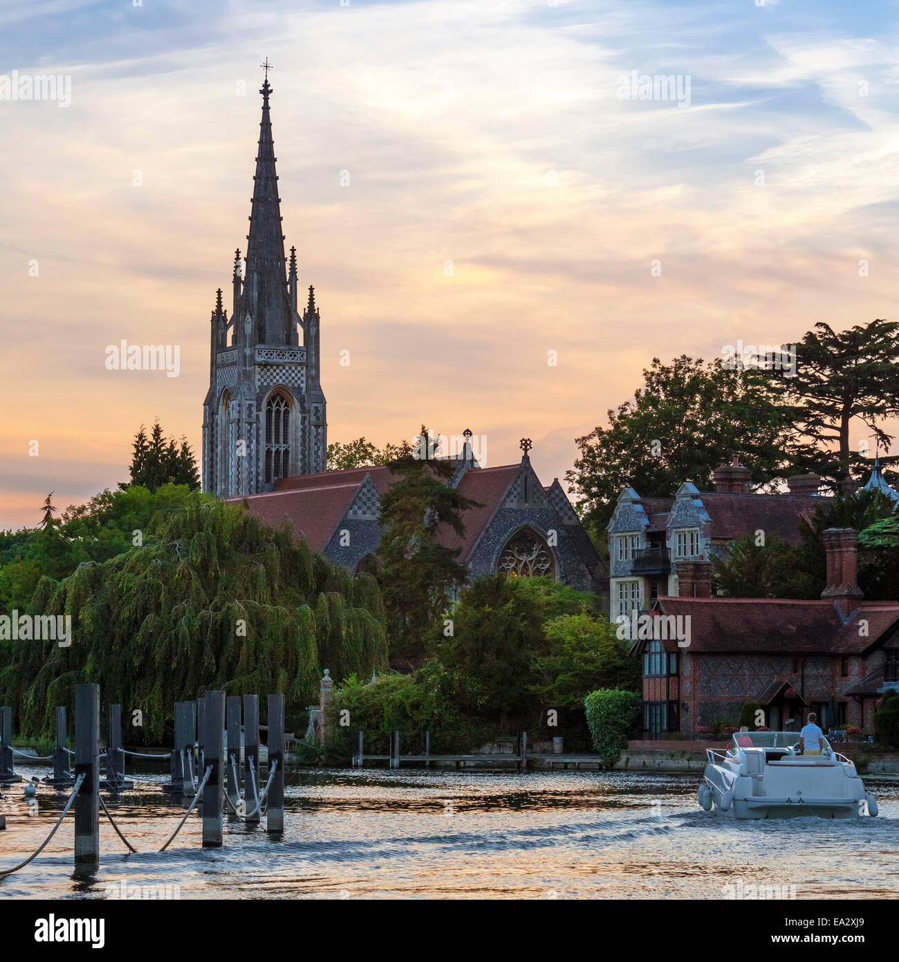 Man and woman on boat with All Saints Church in the background, Marlow, Buckinghamshire, England, United Kingdom, Europe Stock Photo