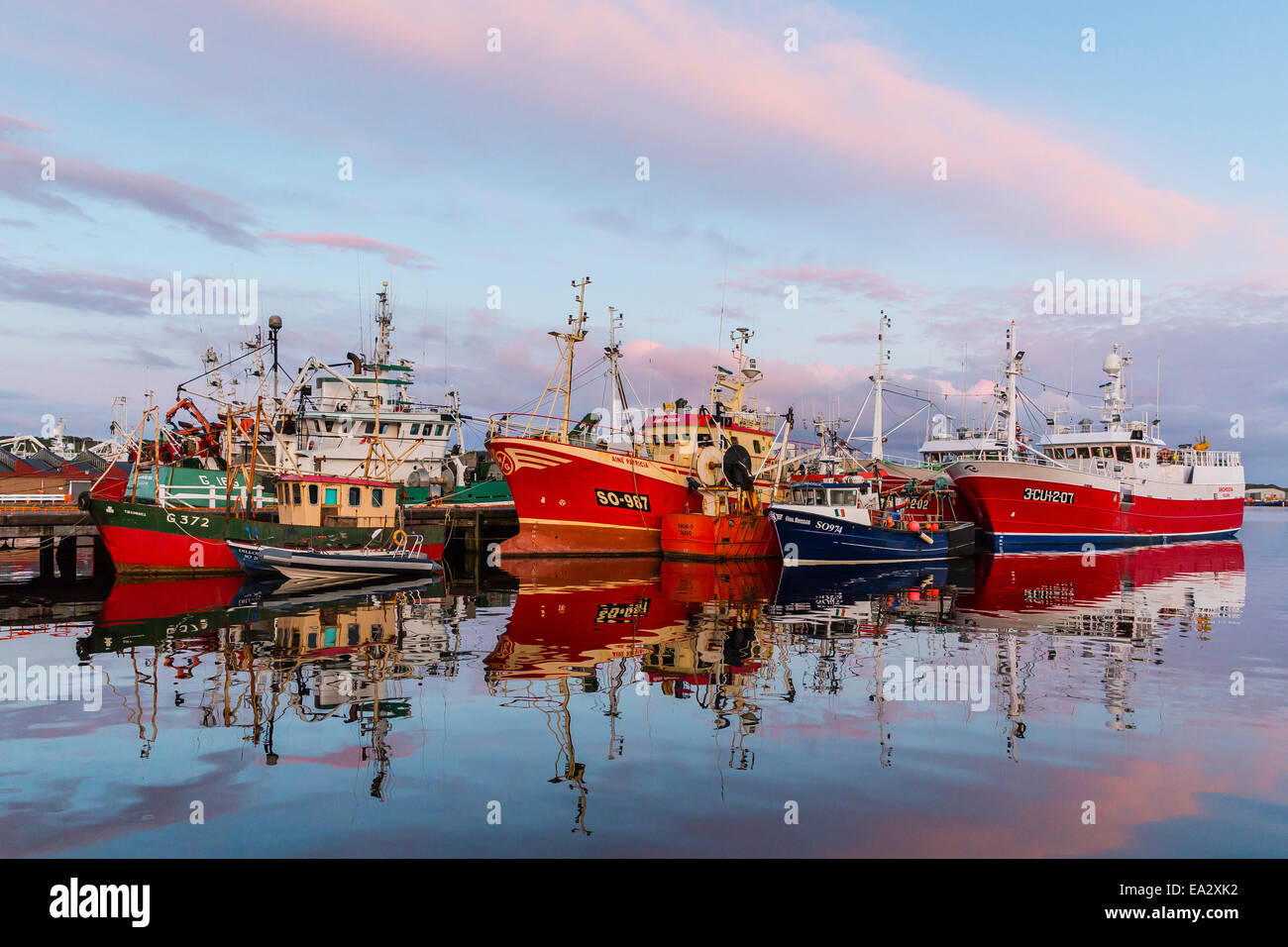 Sunset reflected on the commercial fishing fleet at Killybegs, County Donegal, Ulster, Republic of Ireland Stock Photo