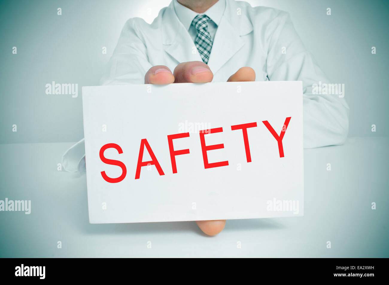closeup of a doctor showing a signboard with the word safety written in it Stock Photo