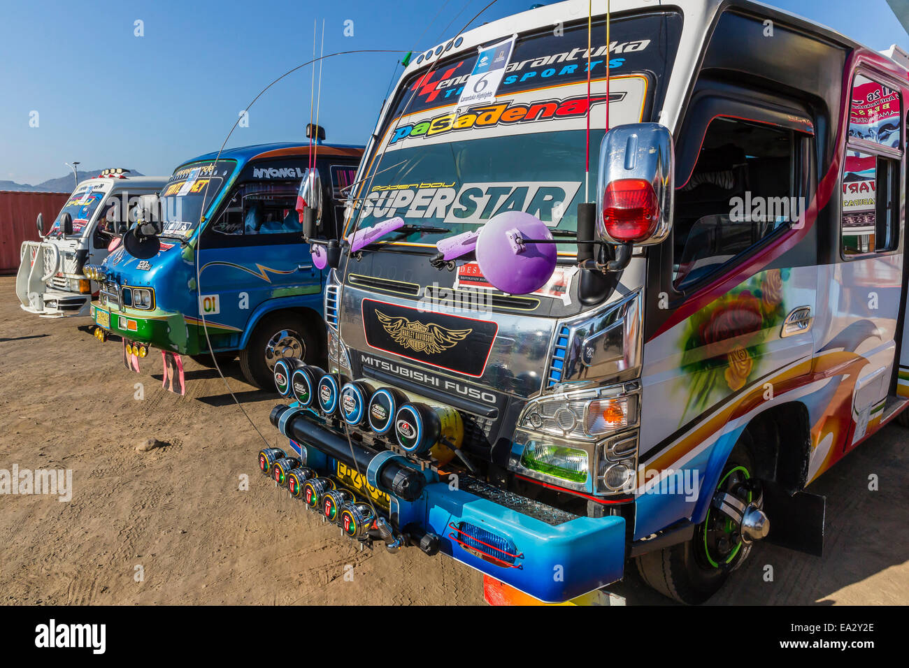 Highly decorated public buses in the busy port city of Larantuka, on Flores Island, Indonesia, Southeast Asia, Asia Stock Photo