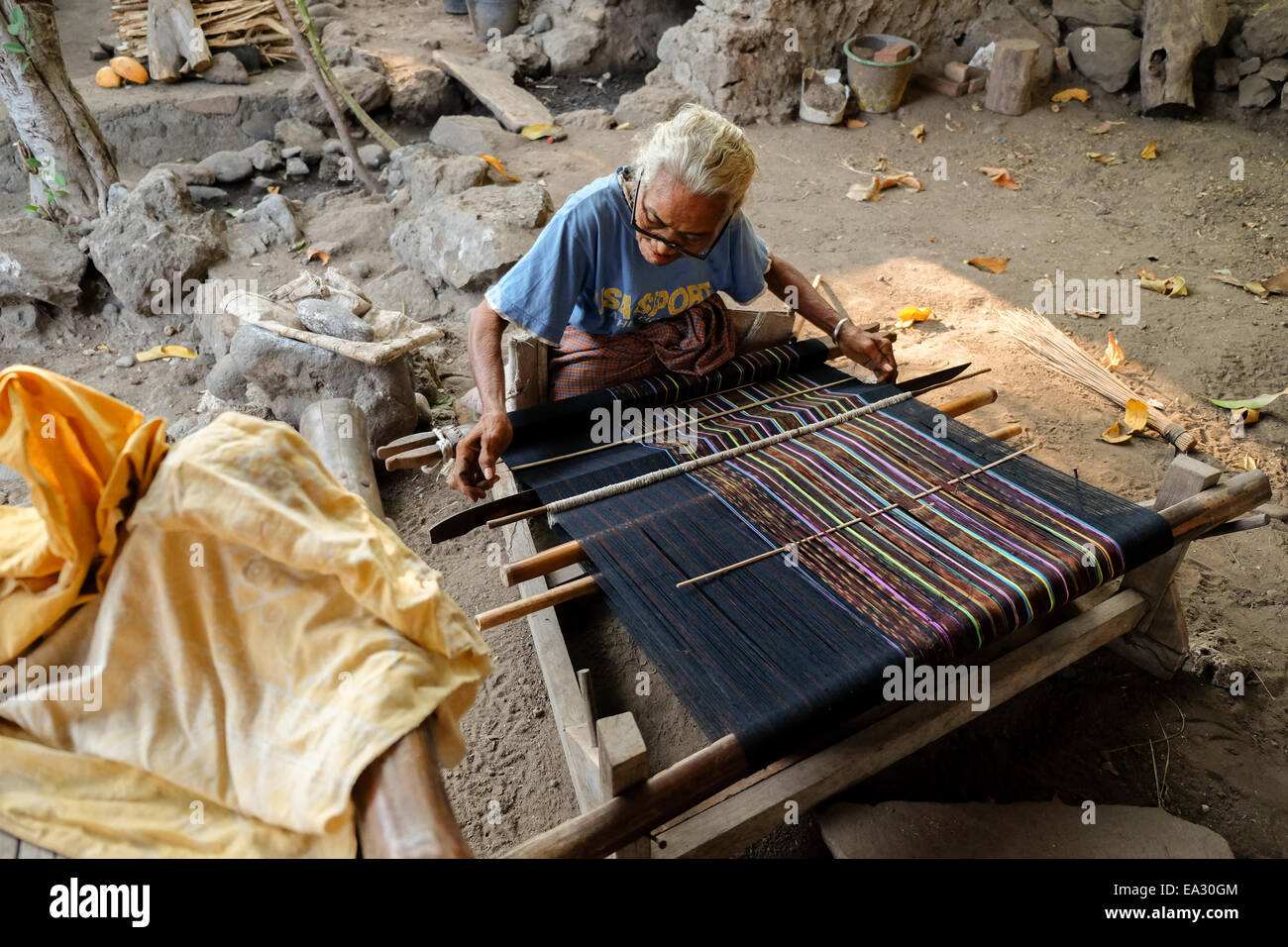 A woman weaving at her workshop--a traditional, alternative source of income in Lamagute village, Lembata, Indonesia. Stock Photo
