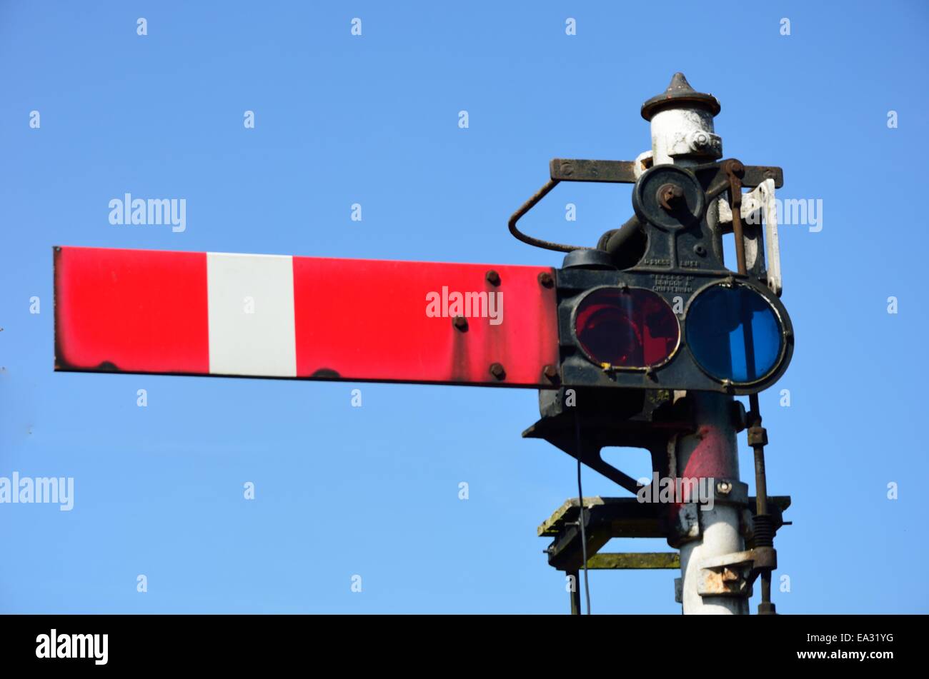 Red rail signal with blue sky Stock Photo