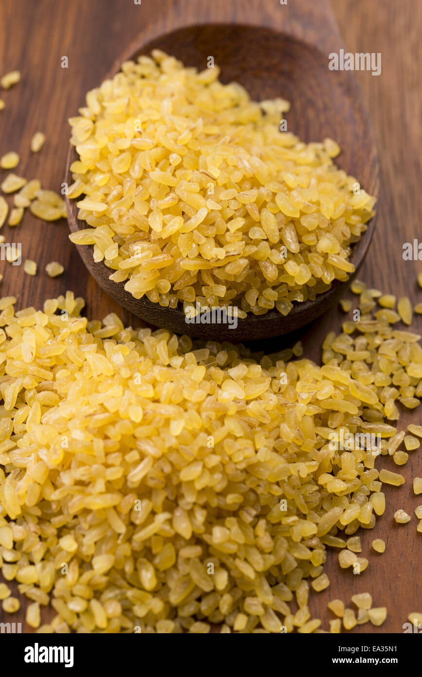 bulgur wheat in wooden spoon Stock Photo - Alamy