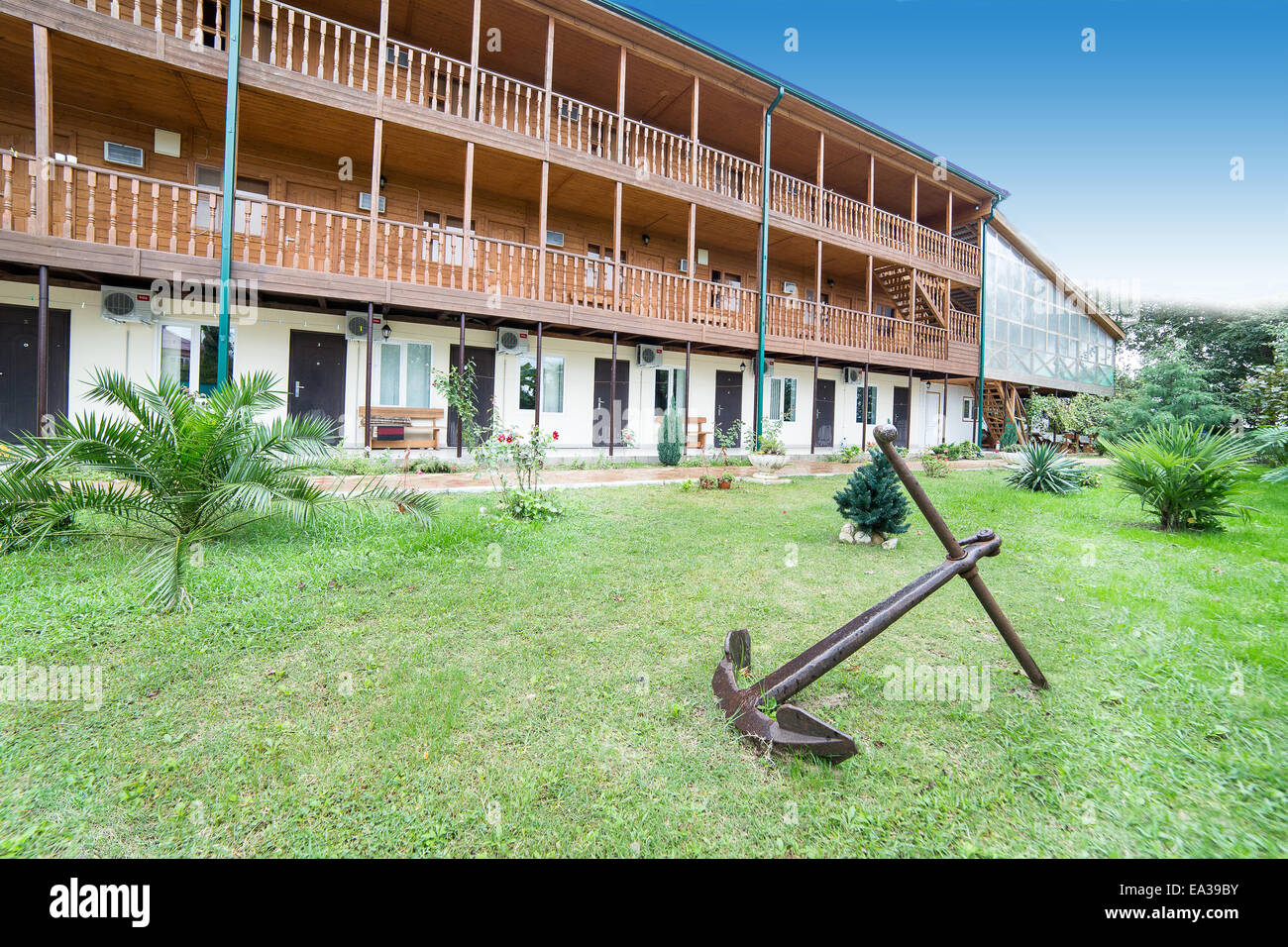 Old anchor in front of hotel building, Abkhazia Stock Photo