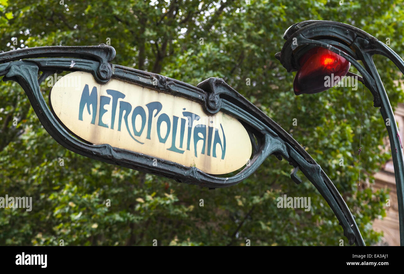 Art-Deco styled Street sign with red light at the entrance to the Paris Metro Stock Photo
