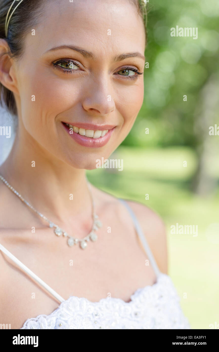 Portrait of bride smiling in garden Stock Photo - Alamy
