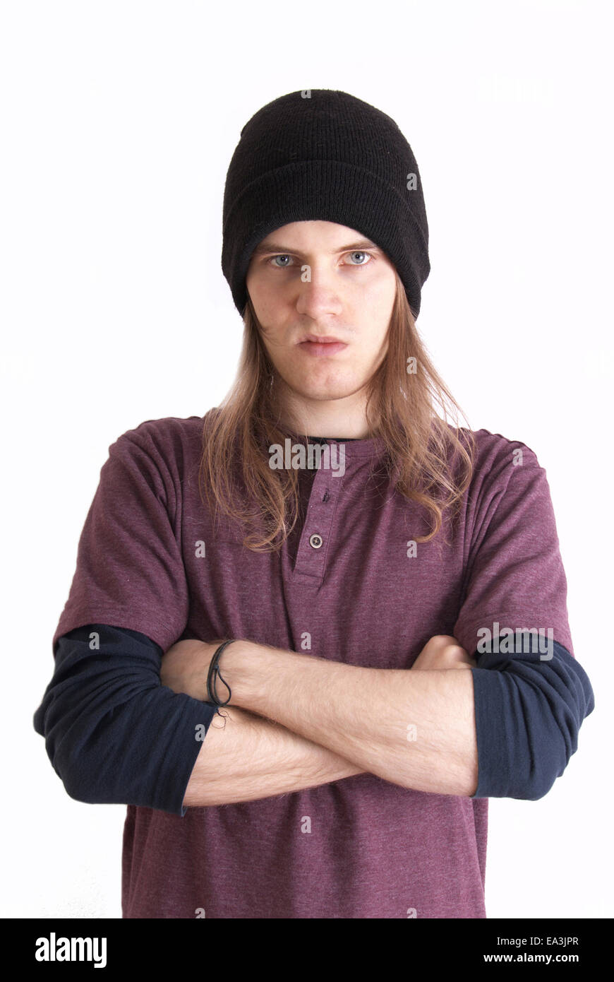 Emotions conceputal image. Angry rebellious teenager with long hair. Stock Photo
