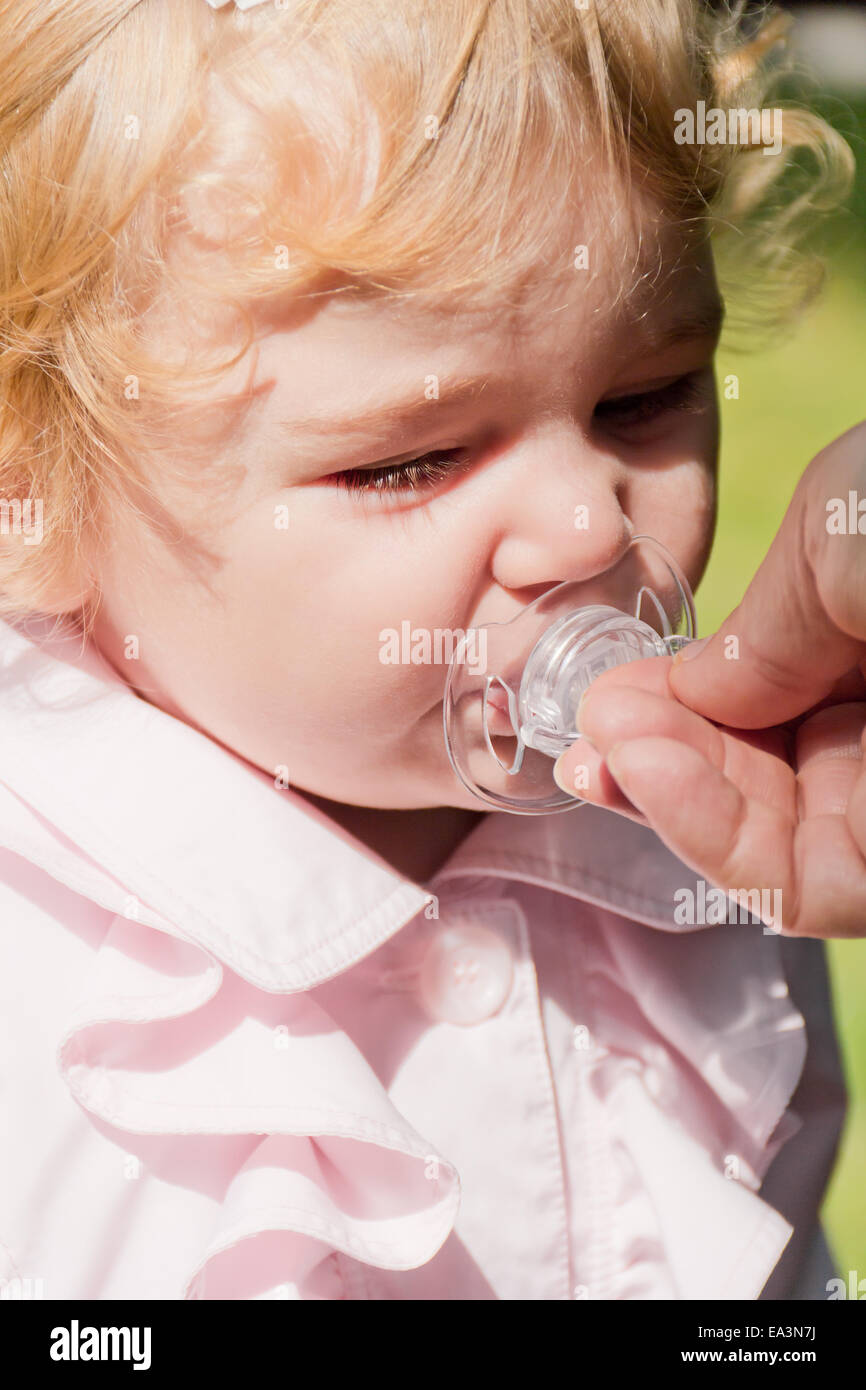 Cute infant with nipple Stock Photo