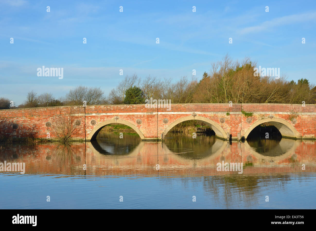 Large arched redbrick river bridge Stock Photo